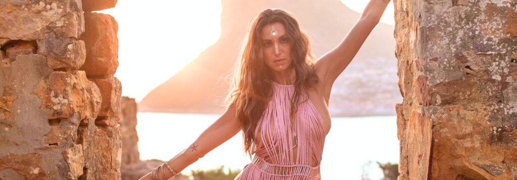 Simona Ferrari on Chapmans peak drive cape town south africa wearing a macrame dress in pink.